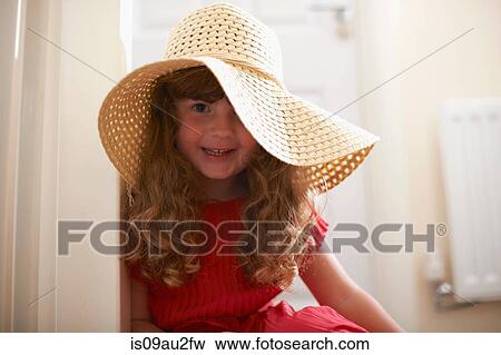 Stock Photo - Portrait of cute girl wearing straw hat. Fotosearch