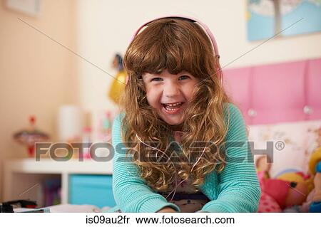 Portrait of girl in bedroom wearing headphones View Large Photo Image Stock Photography - Portrait of girl in bedroom wearing headphones. Fotosearch