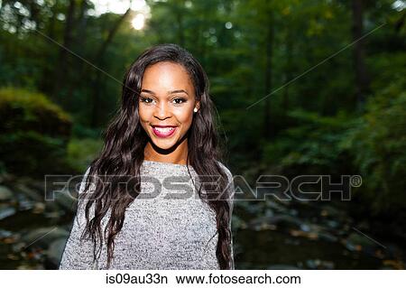 Portrait of happy young woman in darkened forest View Large Photo Image Picture - Portrait of happy young woman in darkened forest. Fotosearch