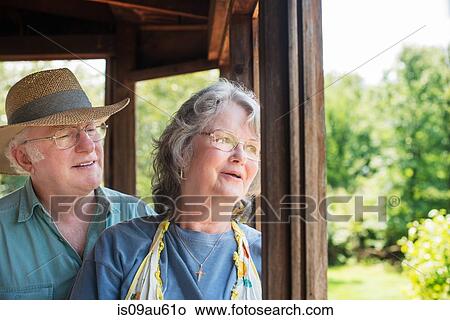 Portrait of senior couple looking out of window smiling View Large Photo Image Picture - Portrait of senior couple looking out of window smiling. Fotosearch