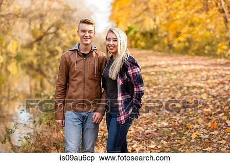 Stock Photography - Portrait of teenage boy and adult sister in autumn forest. Fotosearch