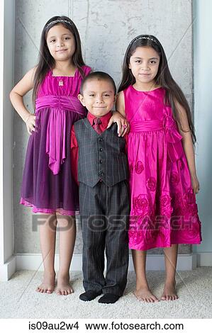 Portrait of three siblings, wearing party clothes View Large Photo Image Picture - Portrait of three siblings, wearing party clothes. Fotosearch