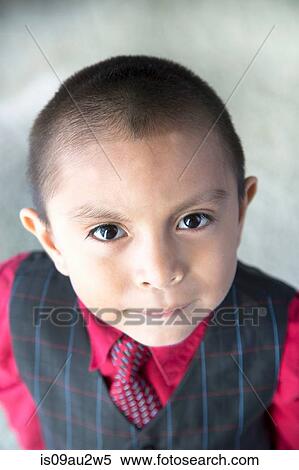 Stock Photography - Portrait of young boy wearing party clothes. Fotosearch
