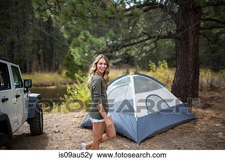 Stock Photo - Portrait of young woman camping on riverside, Lake Tahoe, Nevada, USA. Fotosearch