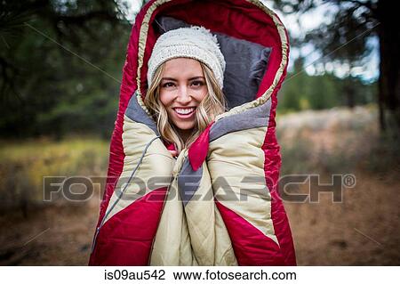 Portrait of young woman wearing knit hat wrapped in sleeping bag, Lake Tahoe, Nevada, USA View Large Photo Image Stock Image - Portrait of young woman wearing knit hat wrapped in sleeping bag, Lake Tahoe, Nevada, USA. Fotosearch