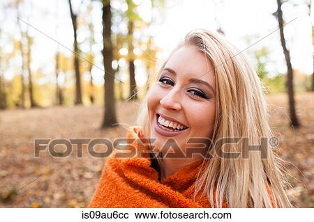 Portrait of young woman with long blond hair wrapped in blanket in autumn forest View Large Photo Image Stock Image - Portrait of young woman with long blond hair wrapped in blanket in autumn forest. Fotosearch