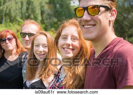 Red haired family group in a row looking at camera smiling View Large Photo Image Stock Photography - Red haired family group in a row looking at camera smiling. Fotosearch