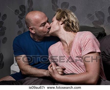 Romantic male couple sitting up in bed kissing View Large Photo Image Stock Photography - Romantic male couple sitting up in bed kissing. Fotosearch