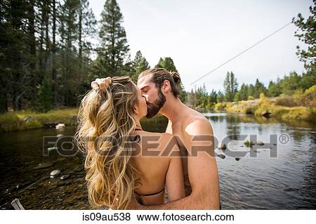 Stock Photo - Romantic young couple kissing in river, Lake Tahoe, Nevada, USA. Fotosearch