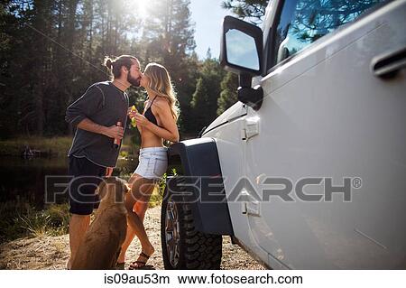 Picture - Romantic young couple kissing on riverside, Lake Tahoe, Nevada, USA. Fotosearch