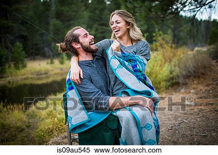 Romantic young couple wrapped in blanket on riverside, Lake Tahoe, Nevada, USA View Large Photo Image Stock Photography - Romantic young couple wrapped in blanket on riverside, Lake Tahoe, Nevada, USA. Fotosearch