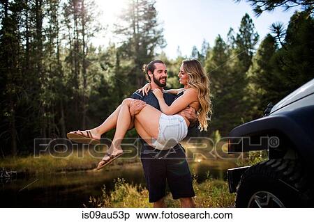 Romantic young man carrying girlfriend on riverside, Lake Tahoe, Nevada, USA View Large Photo Image Stock Photography - Romantic young man carrying girlfriend on riverside, Lake Tahoe, Nevada, USA. Fotosearch