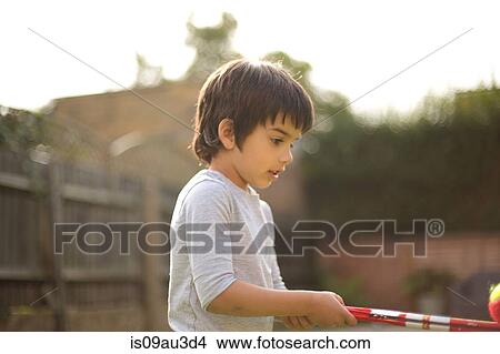 Side view of boy holding toy balancing tennis ball View Large Photo Image Picture - Side view of boy holding toy balancing tennis ball. Fotosearch