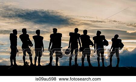 Silhouette of group of young american football players, standing in row View Large Photo Image Stock Photo - Silhouette of group of young american football players, standing in row. Fotosearch