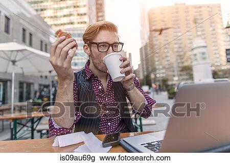 Stressed young businessman hurrying working lunch at sidewalk cafe, New York, USA View Large Photo Image Stock Image - Stressed young businessman hurrying working lunch at sidewalk cafe, New York, USA. Fotosearch