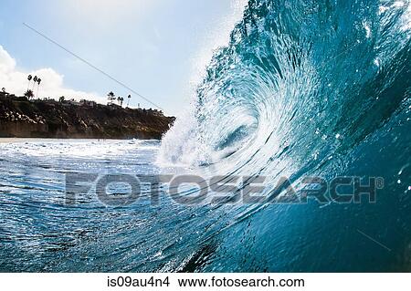 Picture - Surface level view of rolling ocean wave and coastline. Encinitas, California, USA. Fotosearch
