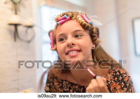 Teenager putting on make-up in bathroom View Large Photo Image Stock Photograph - Teenager putting on make-up in bathroom. Fotosearch