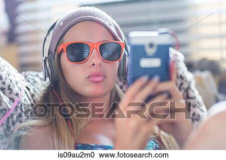 Teenager with sun glasses using smartphone on lazy chair View Large Photo Image Stock Image - Teenager with sun glasses using smartphone on lazy chair. Fotosearch