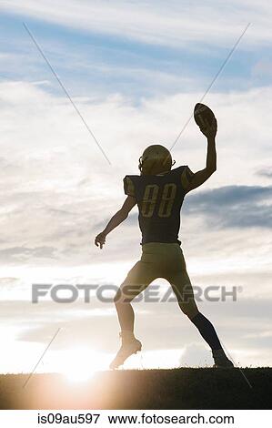 Young american football player about to throw ball View Large Photo Image Stock Photo - Young american football player about to throw ball. Fotosearch