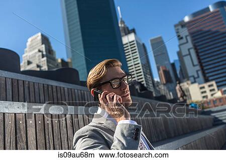Young businessman talking on smartphone, New York, USA View Large Photo Image Picture - Young businessman talking on smartphone, New York, USA. Fotosearch