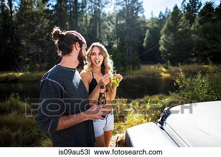 Stock Image - Young couple eating grapes on riverside, Lake Tahoe, Nevada, USA. Fotosearch