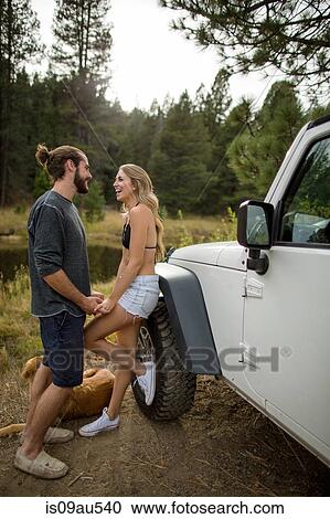 Young couple holding hands next to jeep on riverside, Lake Tahoe, Nevada, USA View Large Photo Image Stock Image - Young couple holding hands next to jeep on riverside, Lake Tahoe, Nevada, USA. Fotosearch