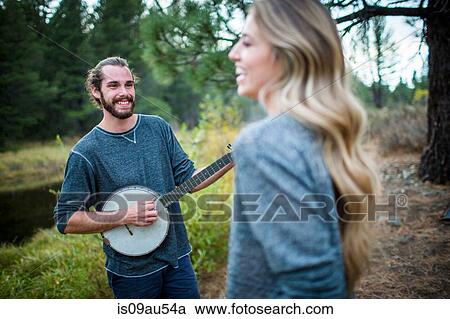 Young couple playing banjo at riverside, Lake Tahoe, Nevada, USA View Large Photo Image Stock Image - Young couple playing banjo at riverside, Lake Tahoe, Nevada, USA. Fotosearch