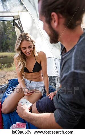 Stock Photo - Young couple playing cards in tent, Lake Tahoe, Nevada, USA. Fotosearch