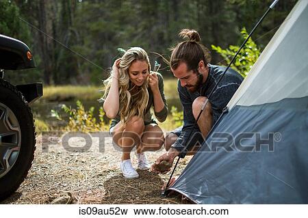 Young couple putting up tent on forest riverside, Lake Tahoe, Nevada, USA View Large Photo Image Stock Photo - Young couple putting up tent on forest riverside, Lake Tahoe, Nevada, USA. Fotosearch