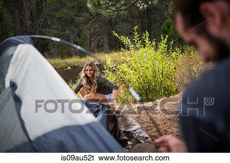 Stock Photograph - Young couple putting up tent on riverside, Lake Tahoe, Nevada, USA. Fotosearch