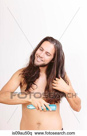 Stock Photography - Young man, brushing long hair. Fotosearch