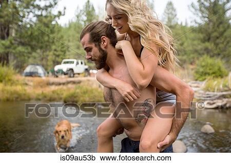 Young man giving girlfriend a piggyback crossing river, Lake Tahoe, Nevada, USA View Large Photo Image Stock Image - Young man giving girlfriend a piggyback crossing river, Lake Tahoe, Nevada, USA. Fotosearch