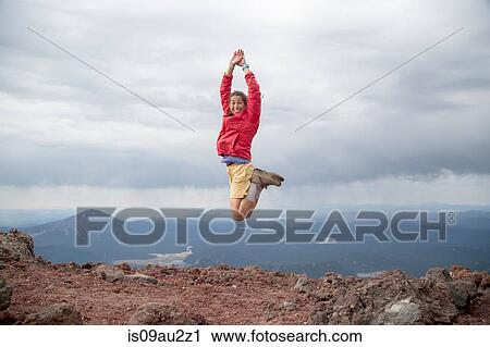 Young woman jumping for joy at the summit of South Sister volcano, Bend, Oregon, USA View Large Photo Image Stock Image - Young woman jumping for joy at the summit of South Sister volcano, Bend, Oregon, USA. Fotosearch