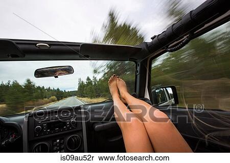Young woman with feet up whilst traveling in jeep View Large Photo Image Stock Photography - Young woman with feet up whilst traveling in jeep. Fotosearch