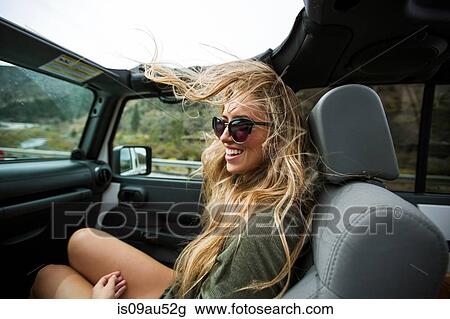 Young woman with windswept long blond hair on the road in jeep View Large Photo Image Stock Image - Young woman with windswept long blond hair on the road in jeep. Fotosearch