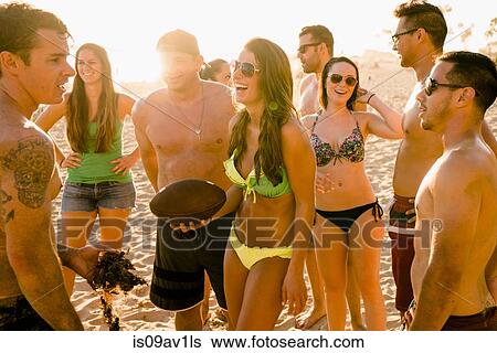 Adult friends with American football ball on Newport Beach, California, USA View Large Photo Image Stock Photograph - Adult friends with American football ball on Newport Beach, California, USA. Fotosearch