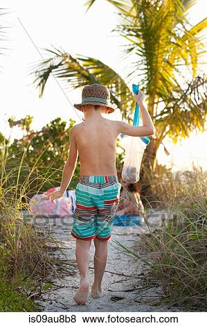 Boy and sister collecting seashells at beach, Sanibel, Florida, USA View Large Photo Image Stock Photo - Boy and sister collecting seashells at beach, Sanibel, Florida, USA. Fotosearch