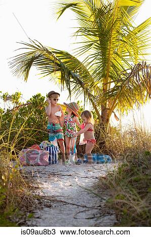 Boy and two sisters collecting seashells at beach, Sanibel, Florida, USA View Large Photo Image Stock Image - Boy and two sisters collecting seashells at beach, Sanibel, Florida, USA. Fotosearch
