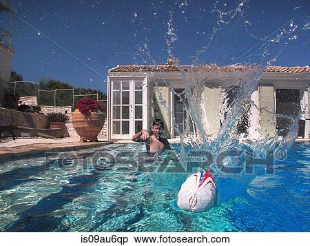 Boy throwing ball in outdoor swimming pool View Large Photo Image Stock Photography - Boy throwing ball in outdoor swimming pool. Fotosearch