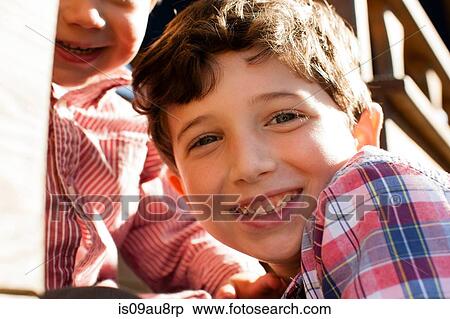 Close up of boy with big brother looking at camera smiling View Large Photo Image Stock Photography - Close up of boy with big brother looking at camera smiling. Fotosearch