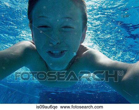 Close up portrait of boy swimming underwater in swimming pool View Large Photo Image Stock Image - Close up portrait of boy swimming underwater in swimming pool. Fotosearch
