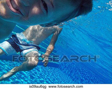 Stock Image - Close up underwater portrait of boy in swimming pool. Fotosearch