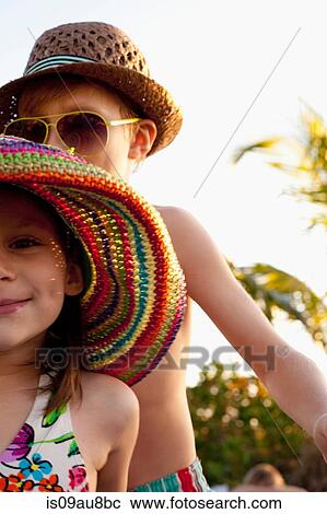 Cropped portrait of girl and brother wearing sunhats on beach, Sanibel, Florida, USA View Large Photo Image Stock Image - Cropped portrait of girl and brother wearing sunhats on beach, Sanibel, Florida, USA. Fotosearch