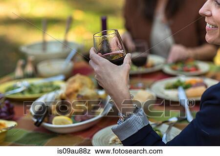 Cropped shot of mature women eating and drinking at garden dinner party View Large Photo Image Stock Photo - Cropped shot of mature women eating and drinking at garden dinner party. Fotosearch