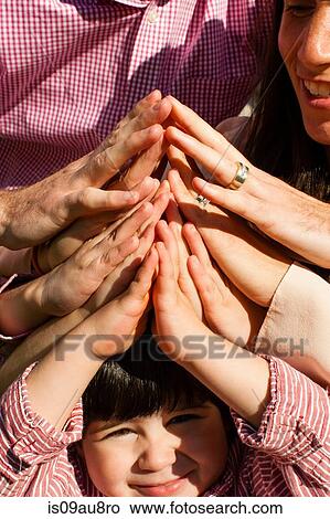 Cropped view of family group holding hands together View Large Photo Image Picture - Cropped view of family group holding hands together. Fotosearch