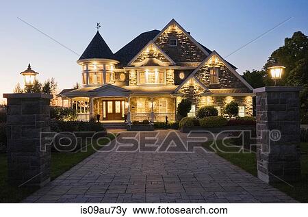Elegant grey stone house with white trim and blue roof at dusk in summer, Quebec, Canada View Large Photo Image Stock Photo - Elegant grey stone house with white trim and blue roof at dusk in summer, Quebec, Canada. Fotosearch