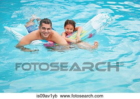 Father and daughter in swimming pool with inflatable mattress looking at camera smiling View Large Photo Image Stock Image - Father and daughter in swimming pool with inflatable mattress looking at camera smiling. Fotosearch