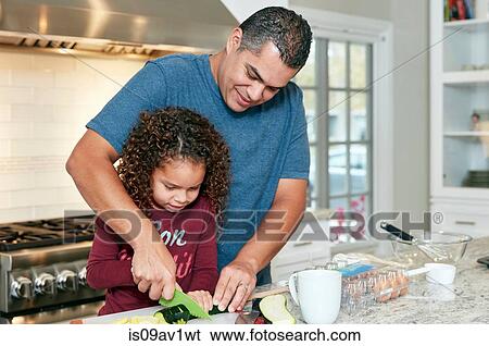 Father helping daughter chop vegetables in kitchen View Large Photo Image Stock Photograph - Father helping daughter chop vegetables in kitchen. Fotosearch