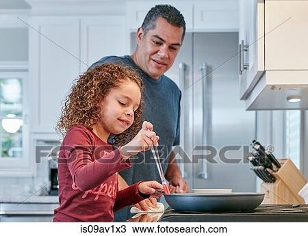 Father helping daughter cook on hob in kitchen View Large Photo Image Stock Image - Father helping daughter cook on hob in kitchen. Fotosearch