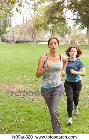 Front view of women wearing sport clothing energetically running on grass View Large Photo Image Stock Image - Front view of women wearing sport clothing energetically running on grass. Fotosearch